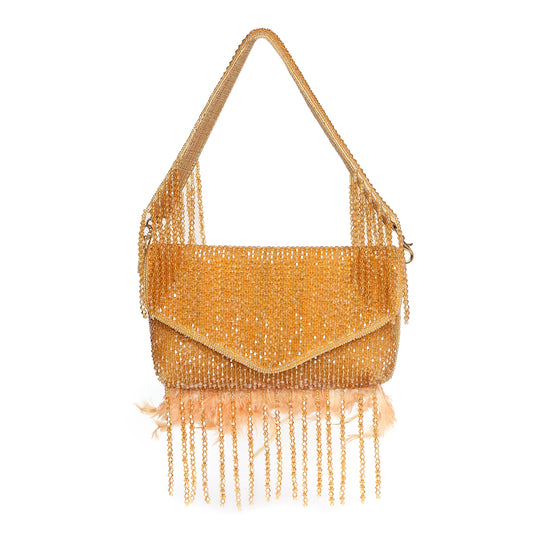 Gold beaded handbag with fringe on a white background