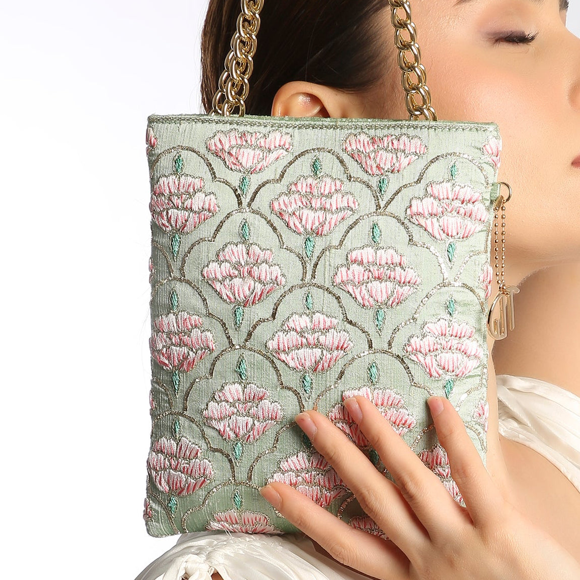 floral patterned handbag with a gold chain strap