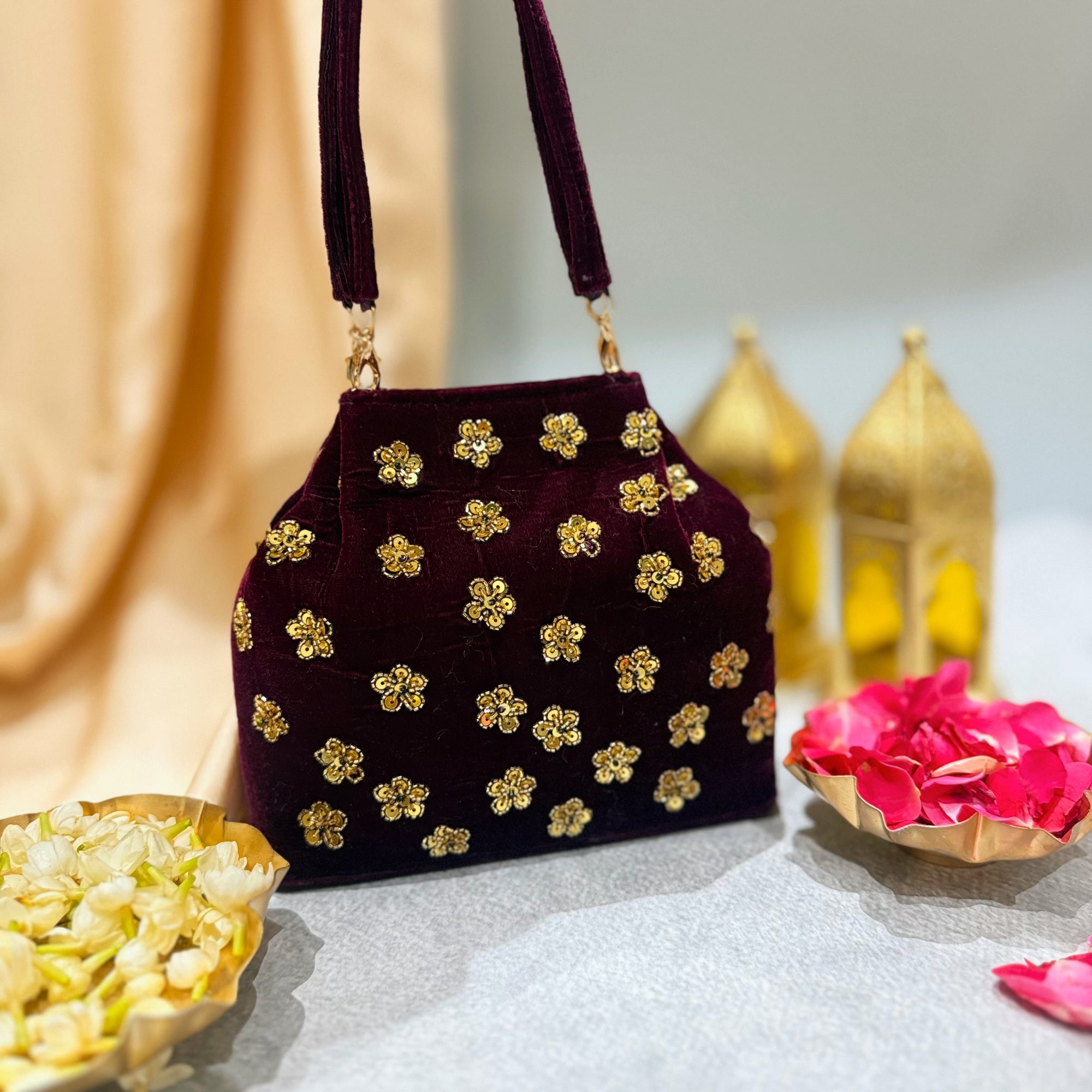 Maroon floral embroidered handbag with golden zardozi detailing 