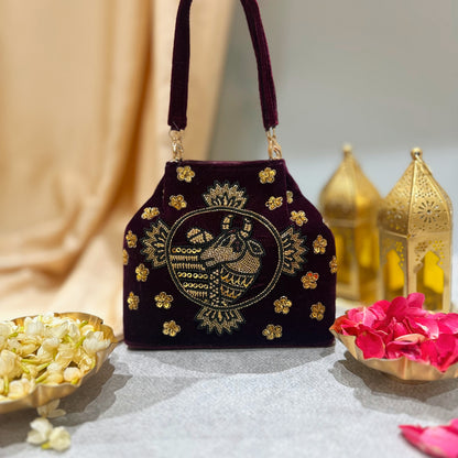 Maroon Cow Motif embroidered handbag with golden zardozi detailing 