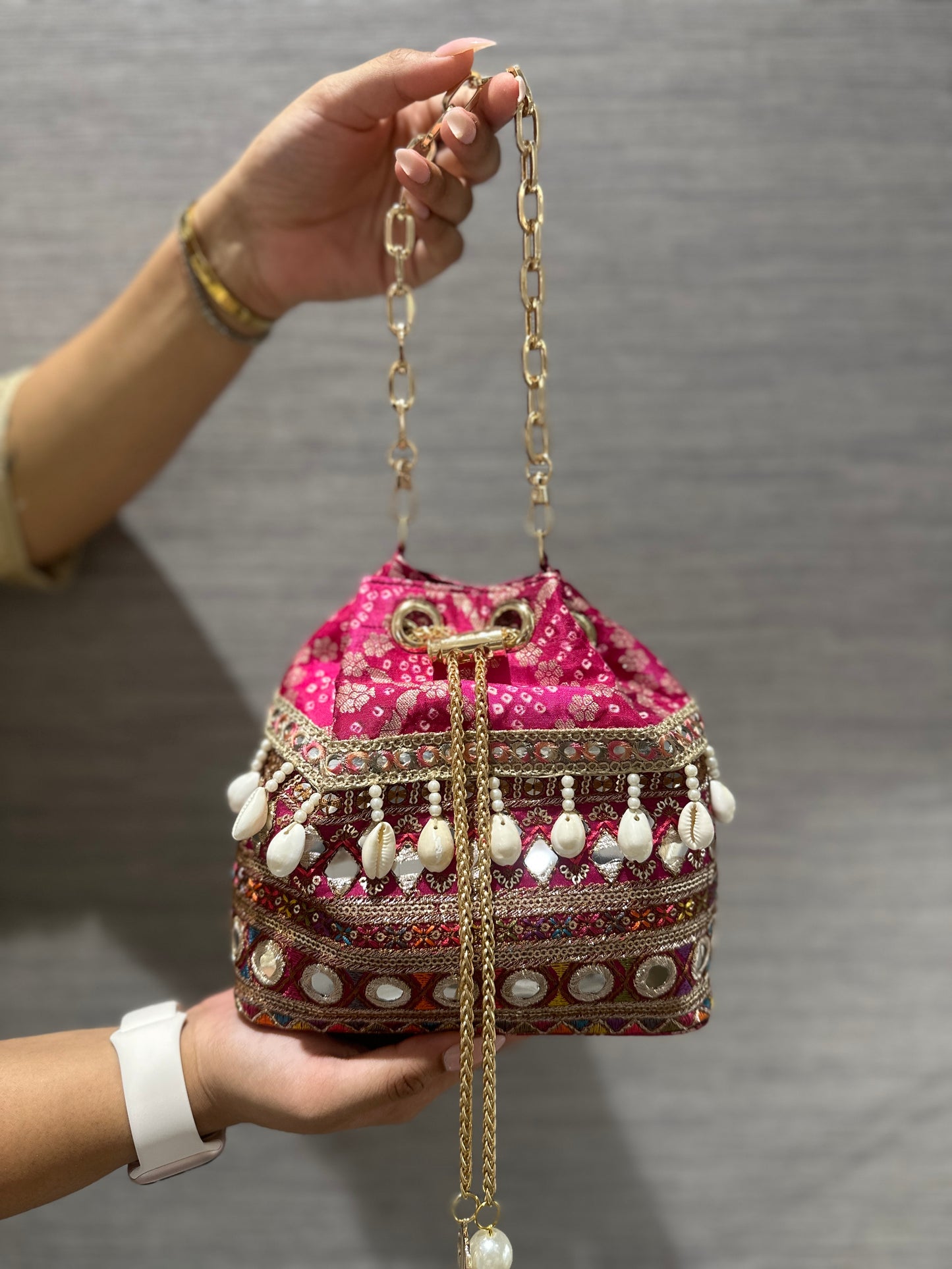 Rani Pink Bandhani Bucket Bag With Mirror Work And Natural Cowrie Shells