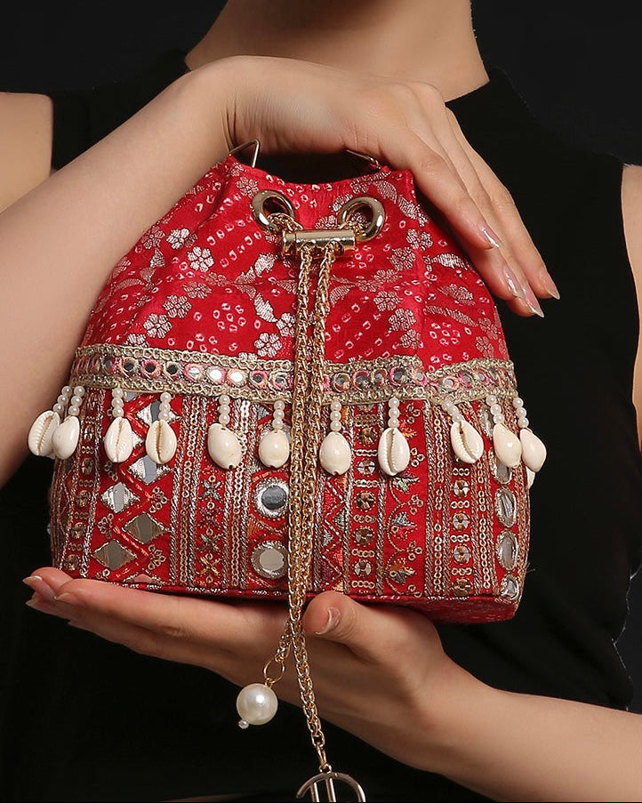 Rani Red Bandhani Bucket Bag with natural cowrie shells and mirror work zari lace