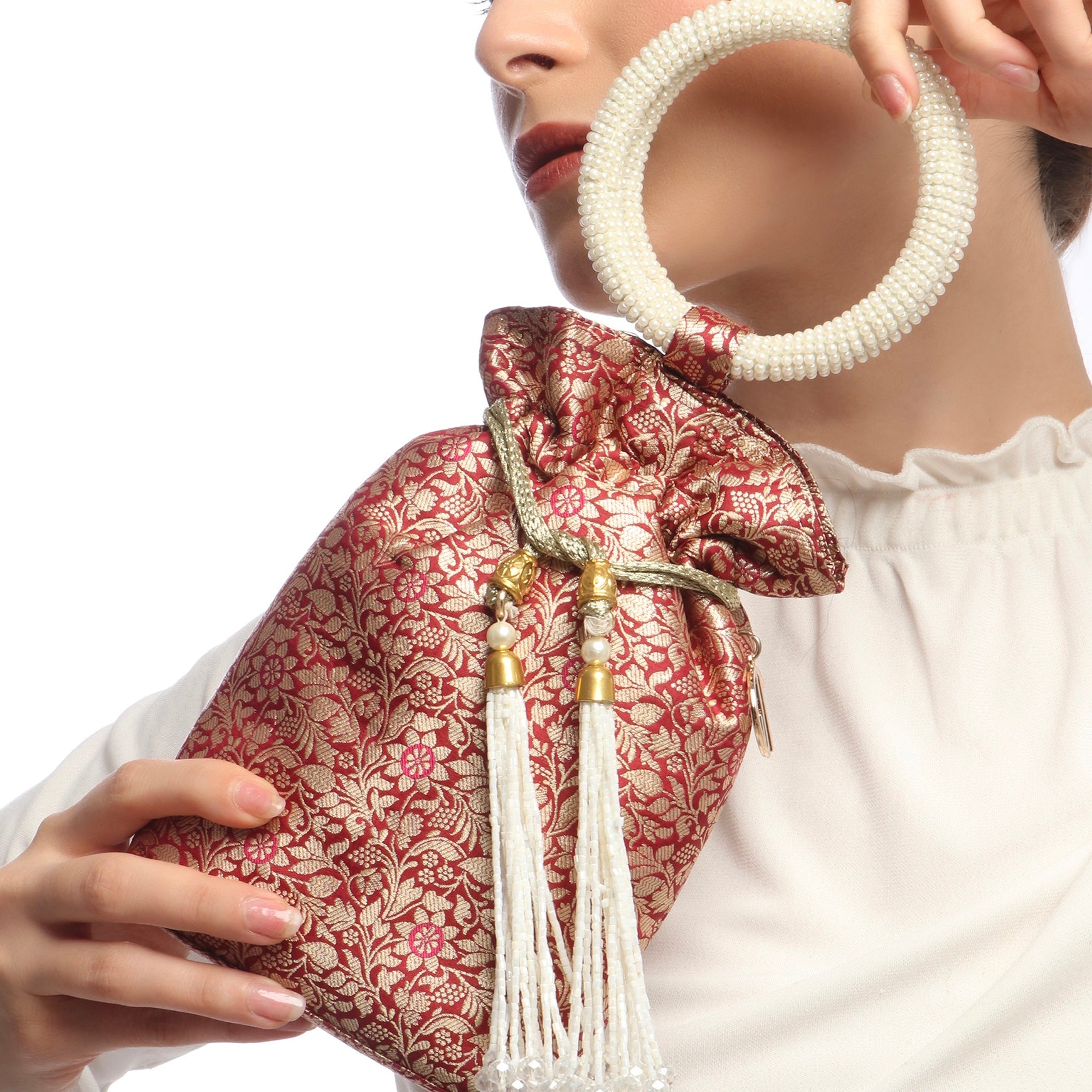 red and gold patterned bag with tassel