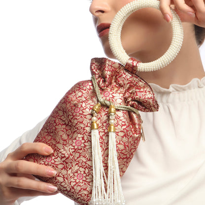 red and gold patterned bag with tassel