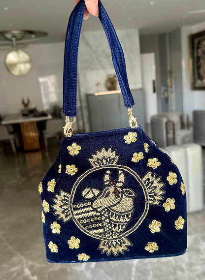 Navy blue embroidered handbag with nandi pichwai in golden zardozi work