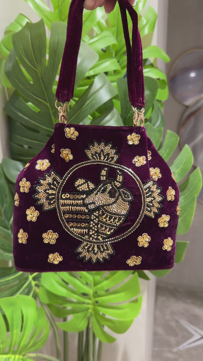 Maroon Cow Motif embroidered handbag with golden zardozi detailing 